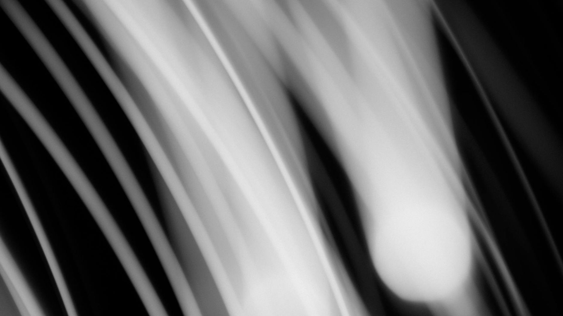 Abstract background with soft light trails suggesting fluid motion.