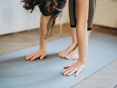 Close-up on feet positioned for a balance exercise on a mat.